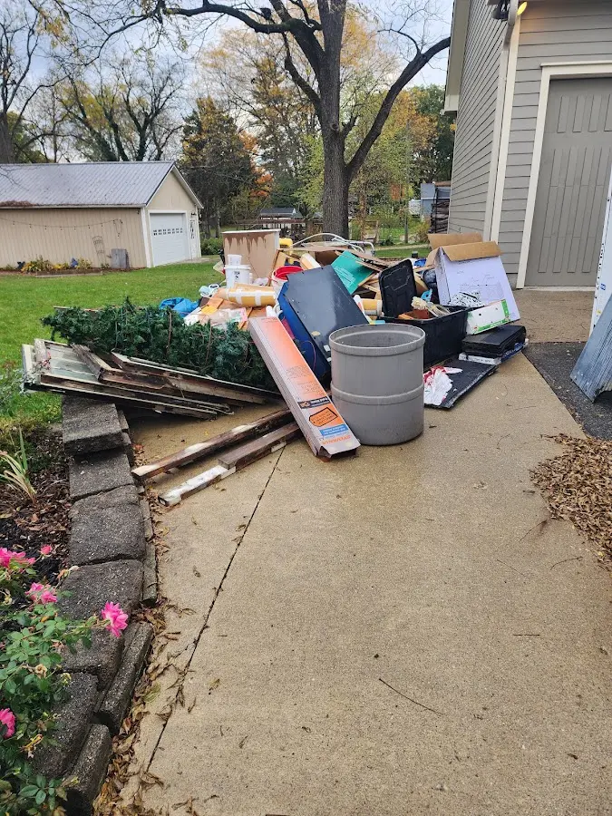 Dumpster being loaded with debris for Estate Cleanout Dumpster Rental in Paradise